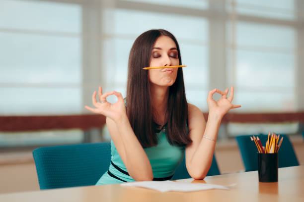Funny Bored Girl Playing with Pencil At Business Meeting Creative employee having a sense of humor during test interview meditation room office stock pictures, royalty-free photos & images