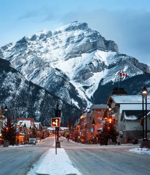 A twilight view of Mount Norquay from Banff Avenue in Banff, Alberta, Canada. The town is an international, year-round tourist destination.