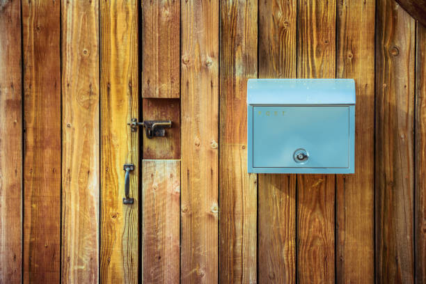 istock Blue mail box hanging on wooden wall 1098181634