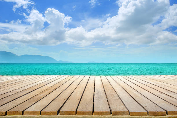 istock wooden table top sea view and blue sky 1098182976