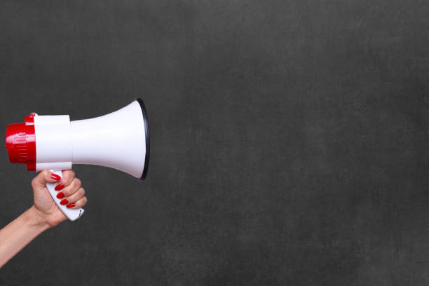 istock Person holding a megaphone or loud hailer 1098188658