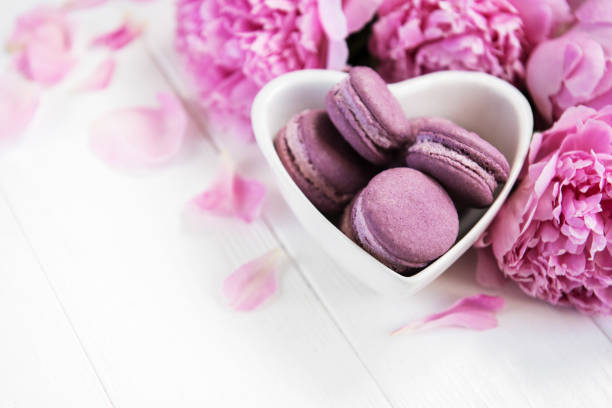 istock Pink peony flowers with macarons 1098190386