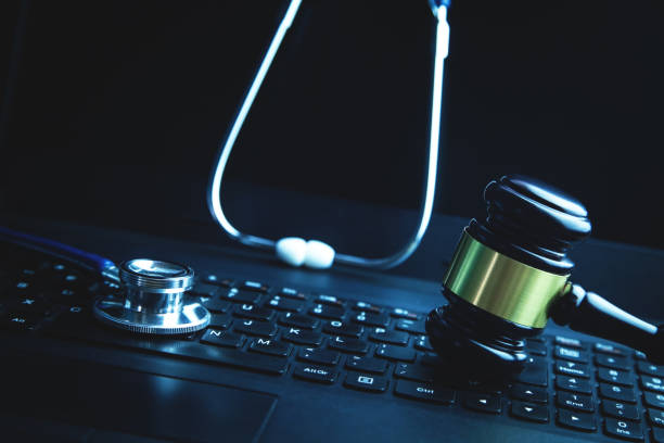istock Gavel with medical stethoscope on laptop keyboard. 1098192308