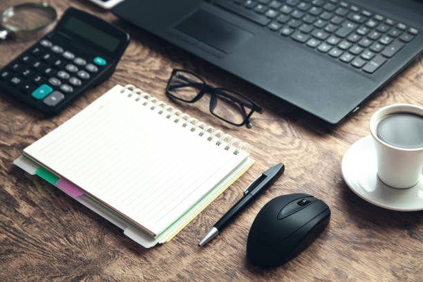 istock Office Workplace. Laptop, notepad, glasses on wooden desk. 1098192322
