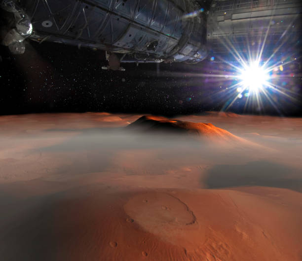 istock Spaceship on the orbit above Mars surface on the background. Elements of this image furnished by NASA. 1098198472