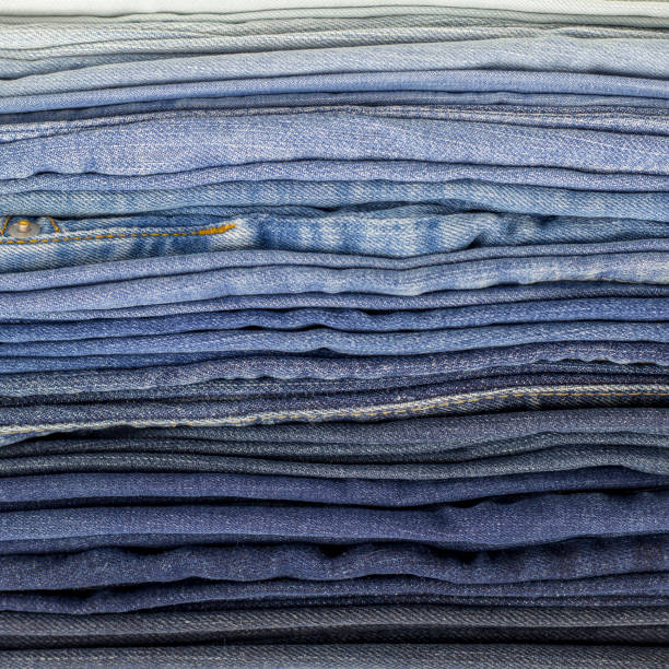 istock Jeans background. Denim texture or denim jeans background, folded from dark blue to light blue, square 1098198496