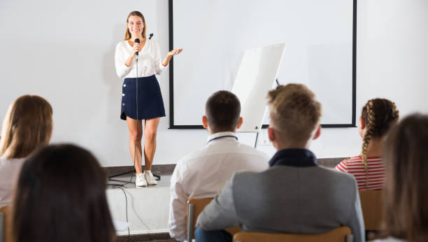 istock Female teacher lecturing to students 1098199910