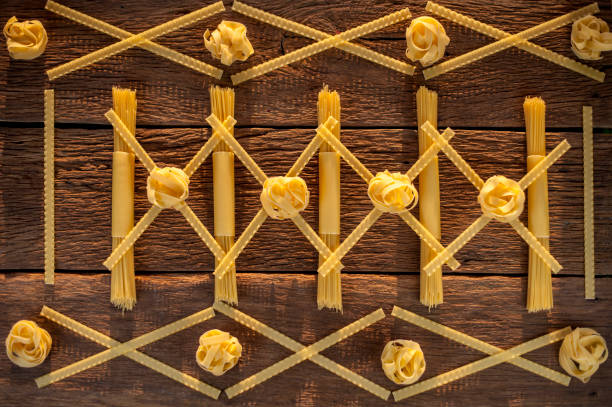 istock pasta placed with geometric signs on a wooden background 1098202892
