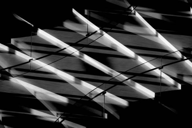 istock Digitally rendered contrast image of staircase with glass balustrade in side lighting. Light and deep shadows on stairs. Modern / futuristic architecture fragment depicted in chiaroscuro technique. 1098203700