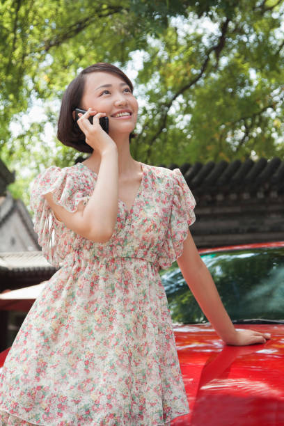 istock Chinese woman talking on cell phone 1098205224