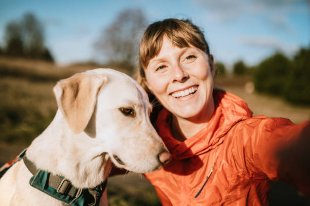 istock Woman Running Outdoors With Pet Dog 1098205592