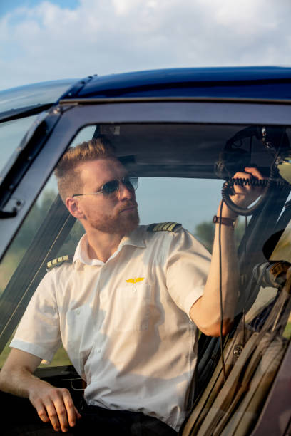 helicopter pilot taking down the headset - aviator glasses audio imagens e fotografias de stock