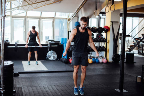 istock Young man skipping rope in the gym 1098211946