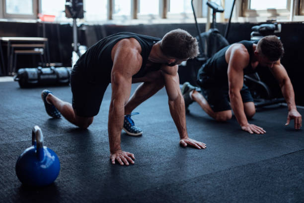 istock Two man doing push ups in the gym 1098212074