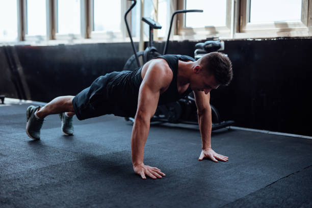 istock Man doing push ups in the gym 1098212076