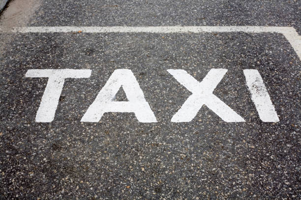 istock Taxi word painted on tarmac 1098214620