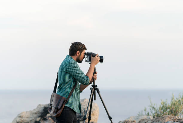 istock Photographer taking picture outdoors 1098217930