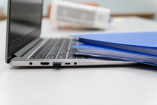 Close Up Blue file folder and Laptop Computer on desk in meeting room stock photo