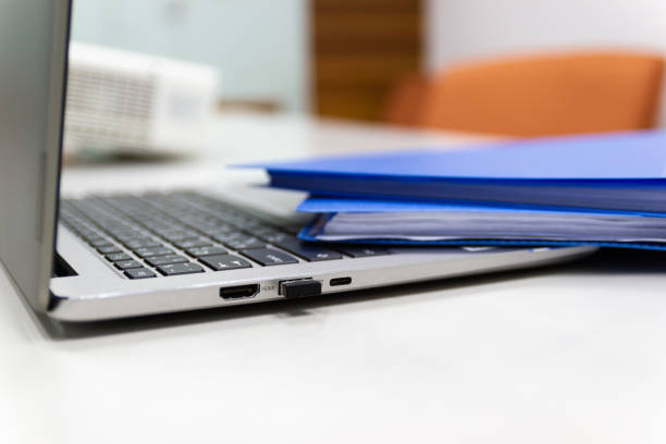 istock Close Up Blue file folder and Laptop Computer on desk in meeting room 1098224636