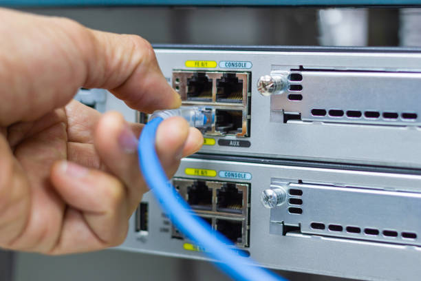 istock Hand of man holding The network cables to connect SFP module port 1098224740
