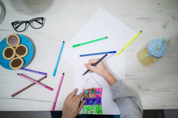 istock Cute little boy drawing at home 1098226598