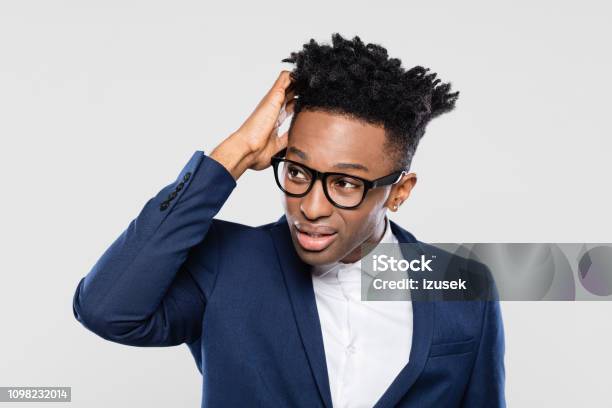 Confused Afro American Businessman Looking Away Stock Photo - Download Image Now - Confusion, Men, Nerd