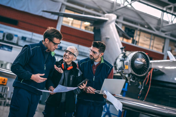 istock Aircraft engineer crew coordinating together in an aircraft hangar 1098232870