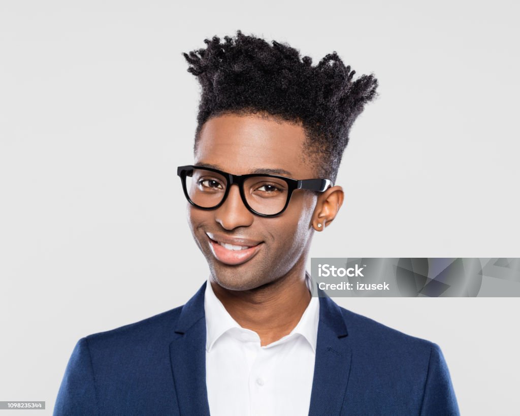 Smart young afro american businessman Close up portrait of smart young afro american businessman in nerd eyeglasses on gray background. Males Stock Photo