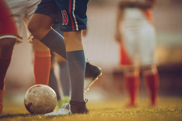 istock Unrecognizable soccer player with a ball on a match. 1098235608