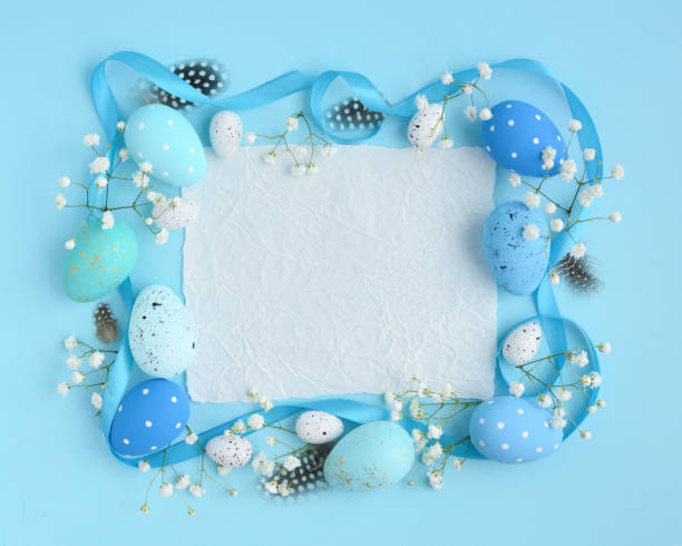 istock Easter eggs on a blue background. View from above, a piece of paper with space for text. Easter card 1098240352
