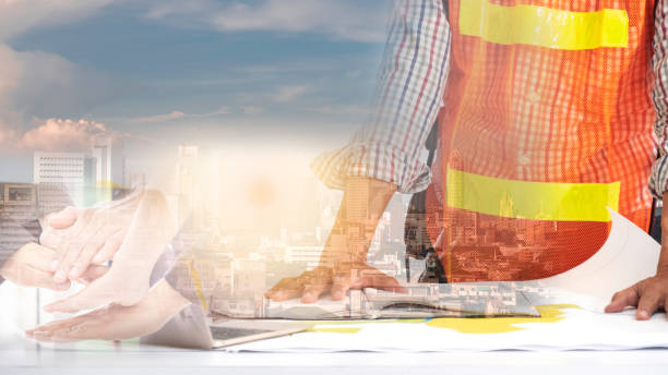 istock Engineer civil and design or architect on drawing paper and construction site with cityscape backgrounds. 1098240640