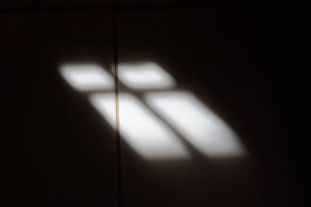 Shadow of window on white tile floor