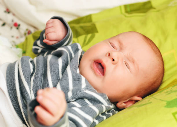 Sneezing newborn week-old baby stock photo