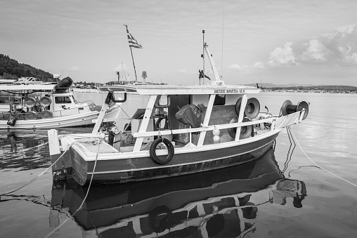 Katakolon, Greece - October 31, 2017: Fishing boats moored in the port of the Katakolon (Olimpia), Greece. Black and white photography.