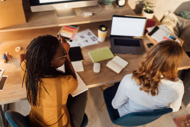 istock Top view of Two Businesswomen Working On Computer In Office 1098255540