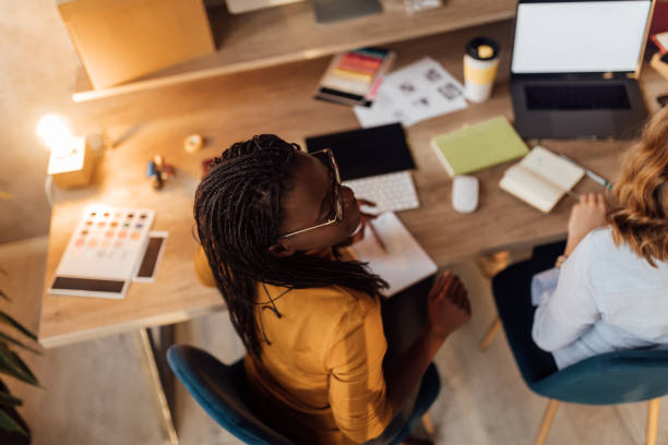 istock Top view of Two Businesswomen Working On Computer In Office 1098255620