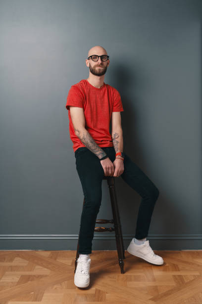 istock Stylish young man posing in the studio on gray background 1098256996