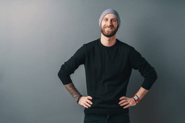 istock Handsome man holding his hands on his hips while smiling to the camera on gray studio background 1098257016