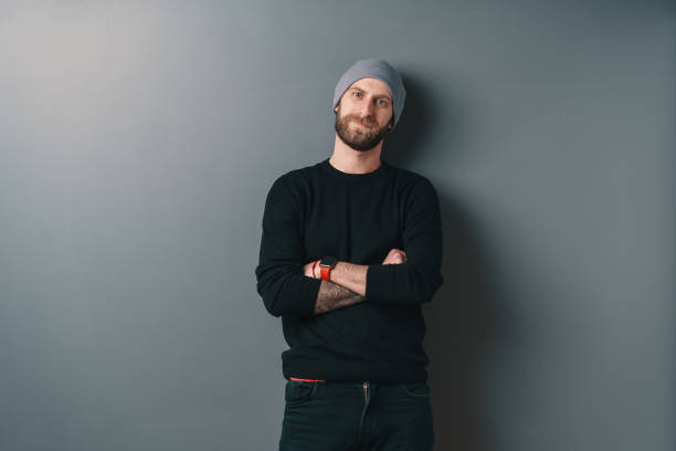 istock Young smiling man with beard standing crossed arms on a gray studio background 1098257026