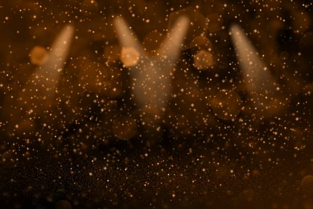 istock orange pretty glossy glitter lights defocused stage spotlights bokeh abstract background with sparks fly, festal mockup texture with blank space for your content 1098258818