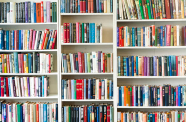 istock Blurred image of colorful bookshelf In secondhand shop. 1098258844