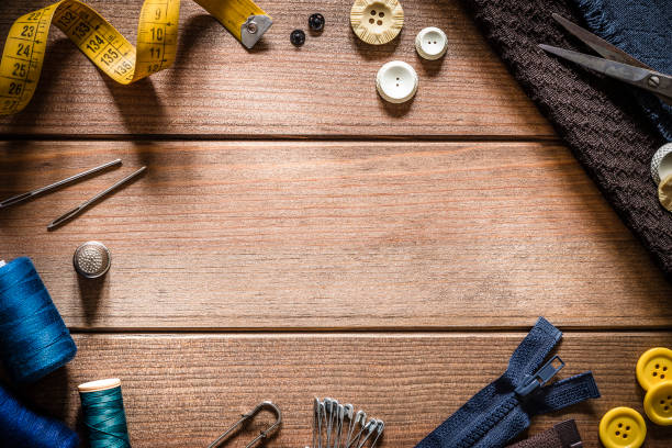 istock Sewings supplies frame on rustic wooden table 1098260688
