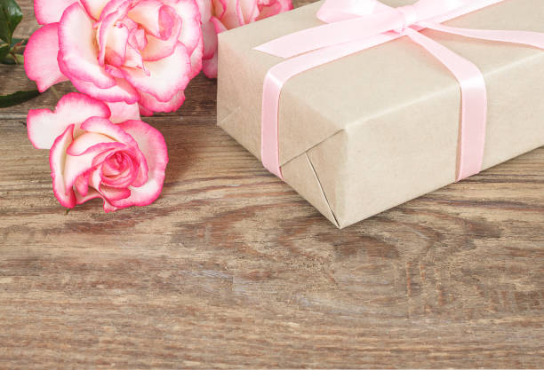 istock Present or gift box in a craft paper with gold ribbon bow 1098261436