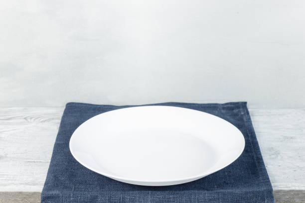 istock Empty plate on tablecloth on wooden table over grunge background 1098261512
