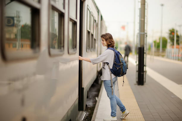 istock Young woman with backpack take the train. 1098261532