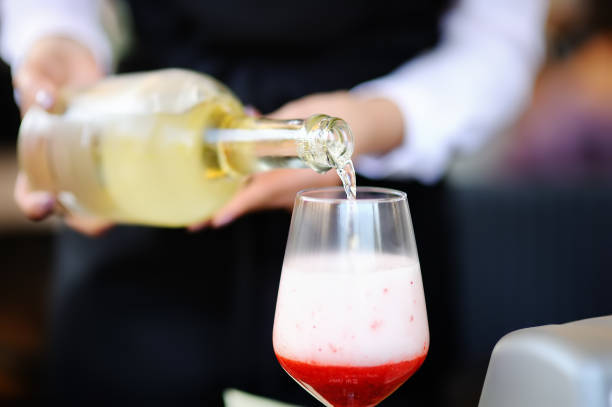 istock Woman bartender pours aperitif into glass 1098261792
