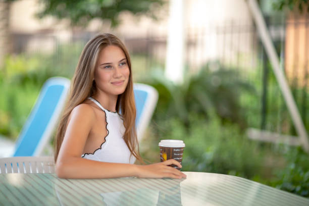 istock Pretty woman in outdoors cafe 1098264572