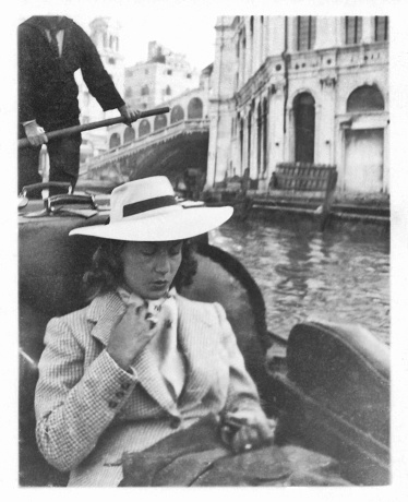 Young beautiful woman on gondola in Venice in 1941