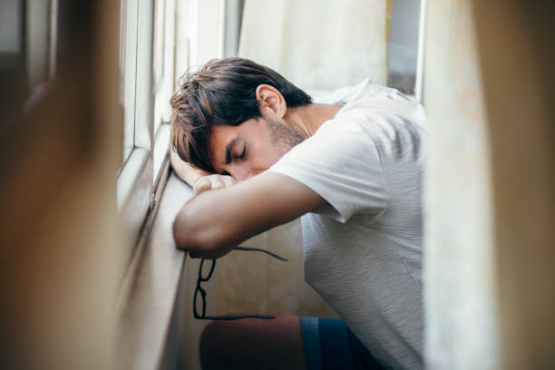 Tired young boy sleeping on sofa at home after study