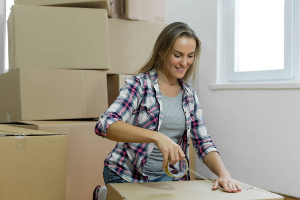 istock Young woman packing for moving 1098267416